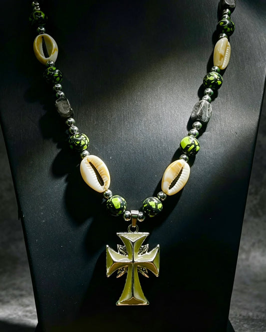 The Earth Rite Necklace — cowrie shells, green and black painted beads, silver accents and gold Maltese cross pendant
