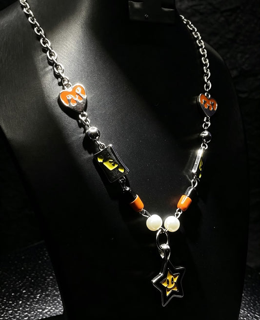 The Midnight Arcade Necklace — silver rolo chain with neon cube charms, orange heart pendants, pearl beads and smiling star drop
