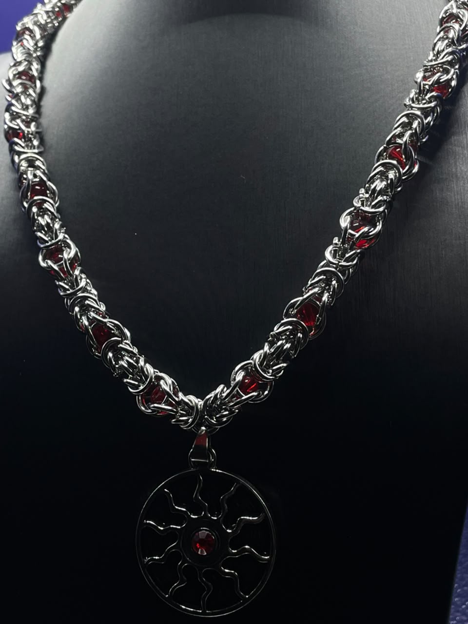 Crimson Solstice Necklace – silver Byzantine chainmail with red crystal accents and circular sun pendant
