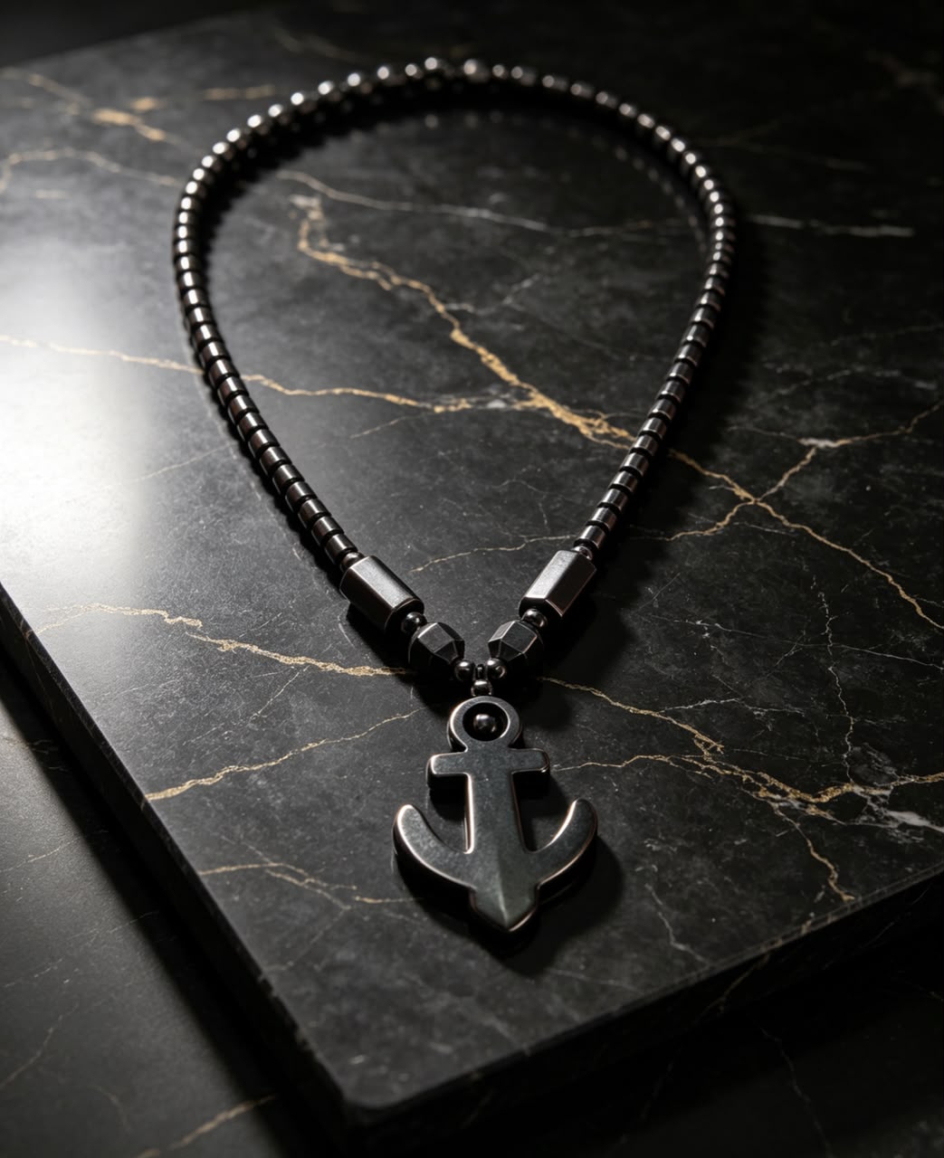 The Anchor Chain Necklace on black marble surface