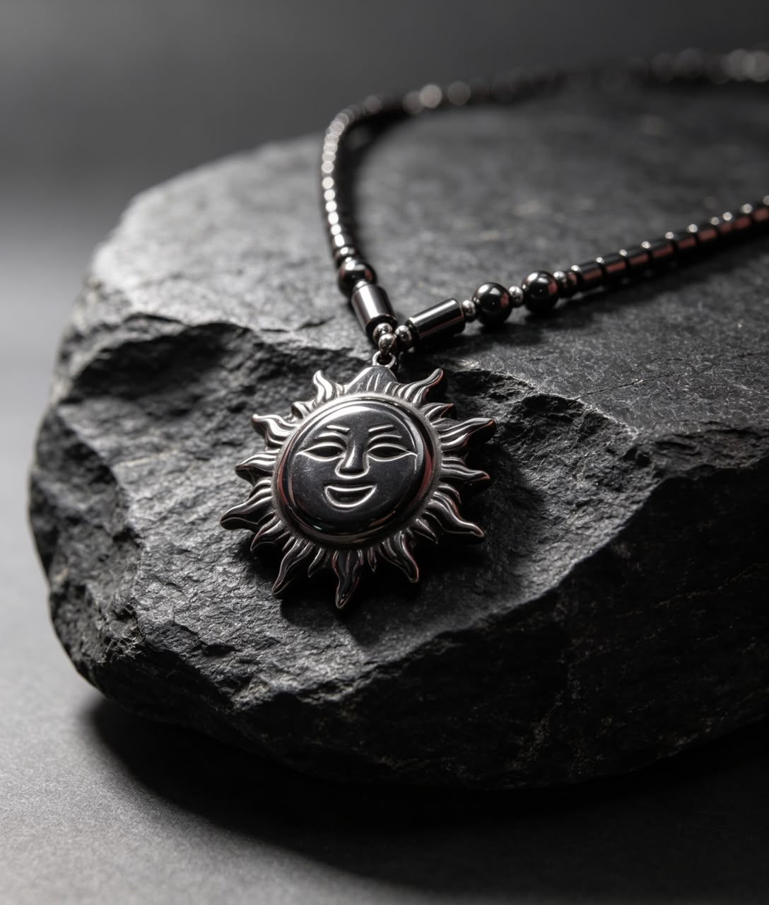 The Midnight Sol Necklace resting on dark stone surface